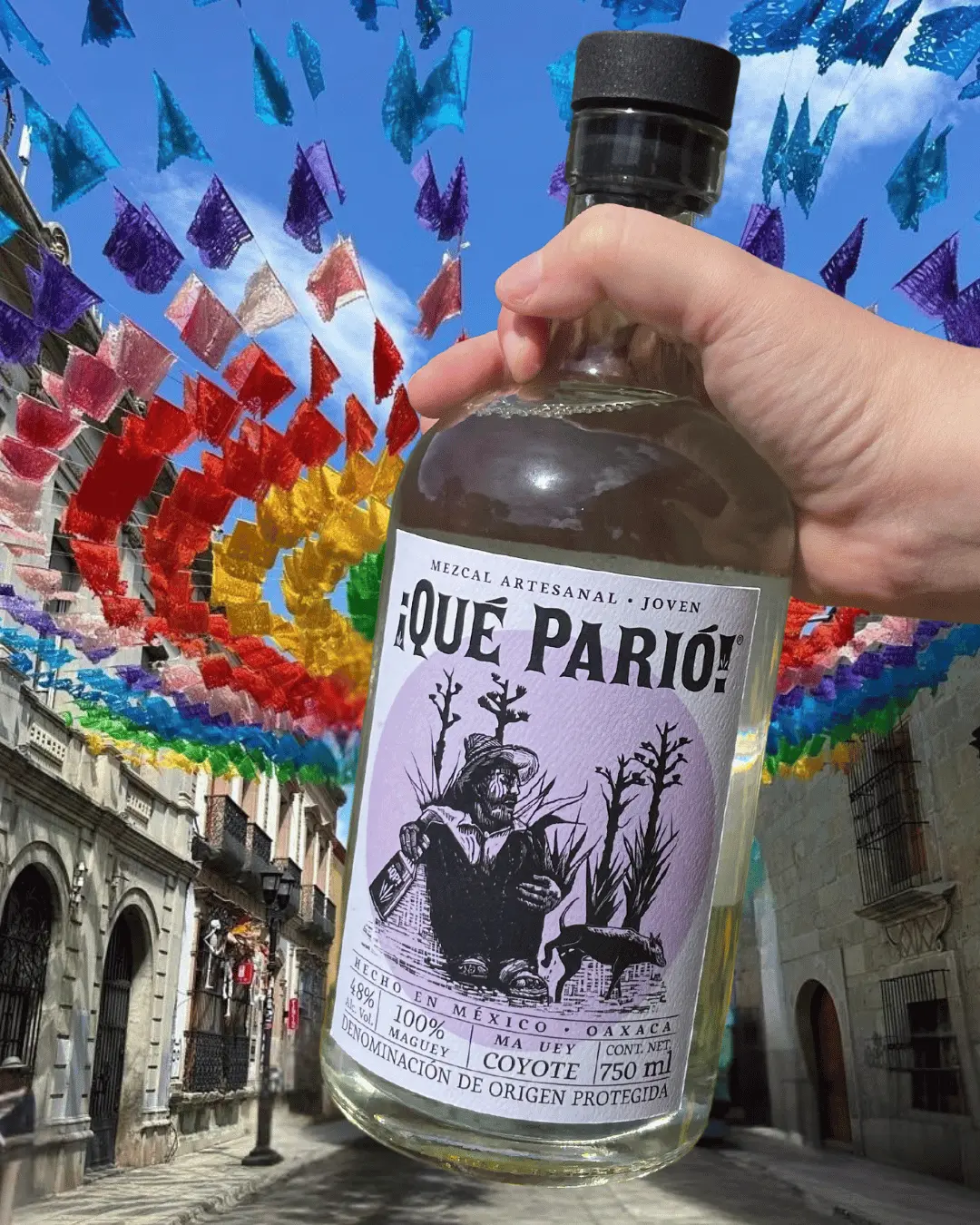 bottle of que pario with flags